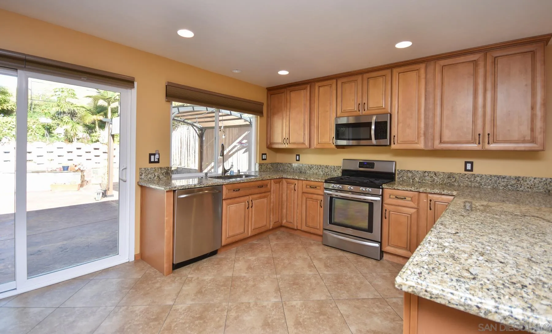 455 Mainsail Road Oceanside, CA 92054 - Photo 7 of 17 a kitchen with granite countertop a stove top oven sink and cabinets