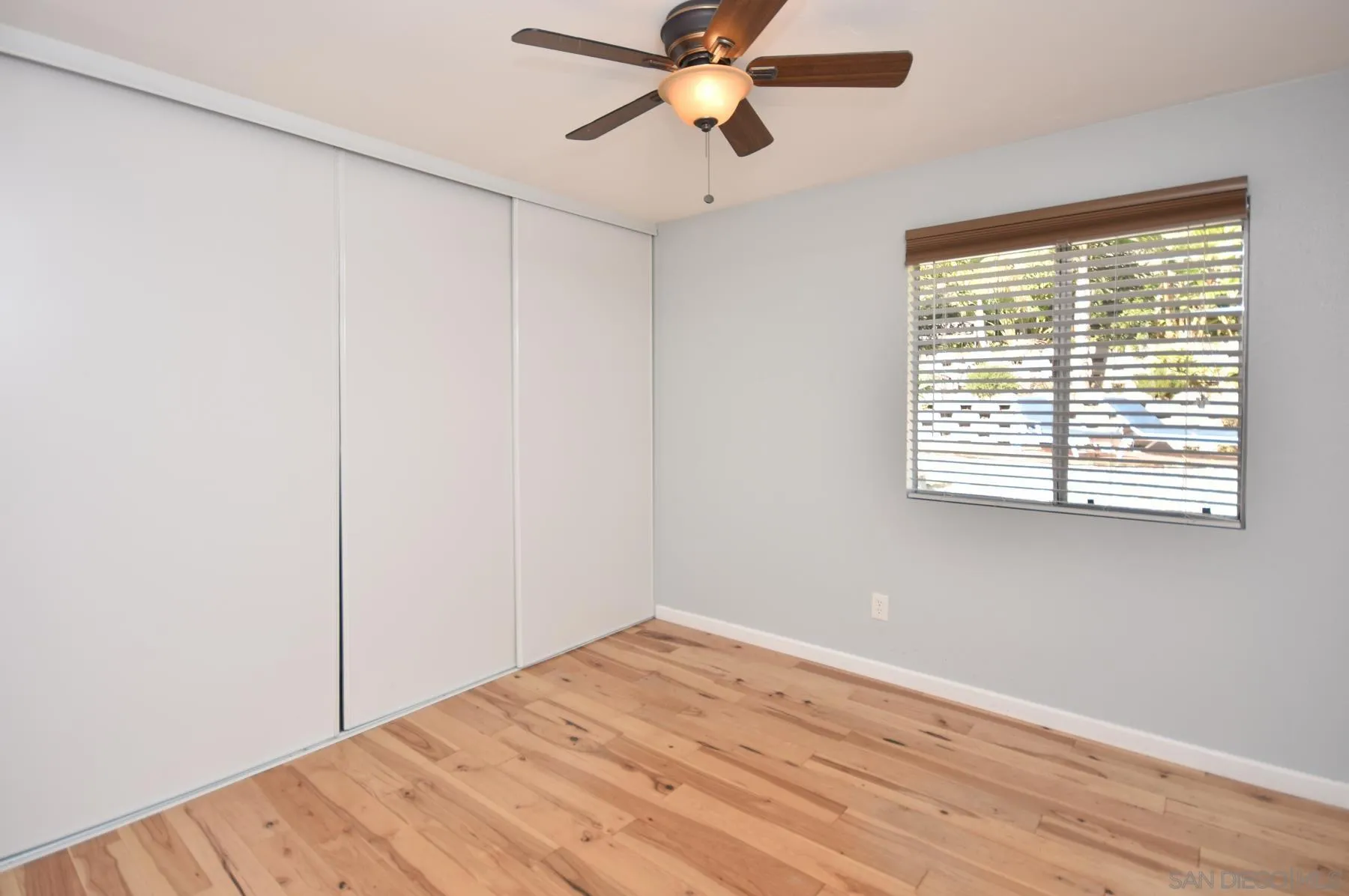 455 Mainsail Road Oceanside, CA 92054 - Photo 9 of 17 a view of empty room with wooden floor and fan