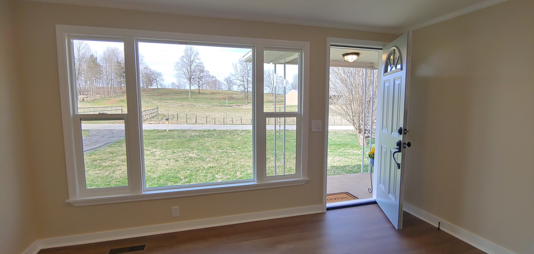 8436 Union Camp Road Pleasant Shade, TN 37145 - Photo 3 of 32 a view of an empty room with wooden floor and a window