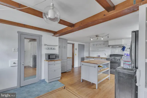 a kitchen with cabinets and wooden floor