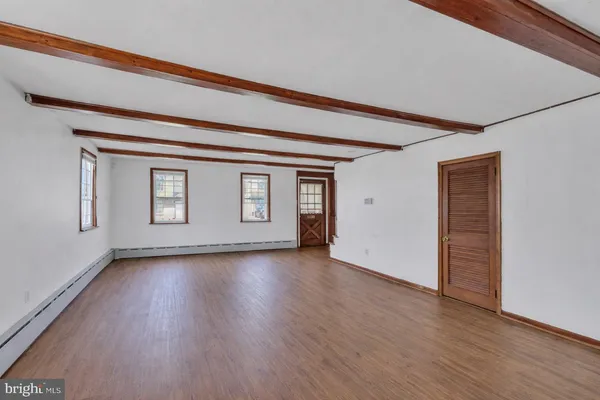 a view of a room with wooden floor and window