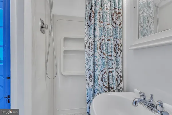 a bathroom with a shower curtain and a sink