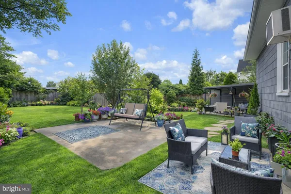 a view of a backyard with sitting area