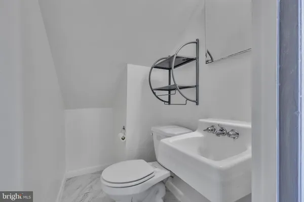 a white toilet sitting next to a bathroom sink
