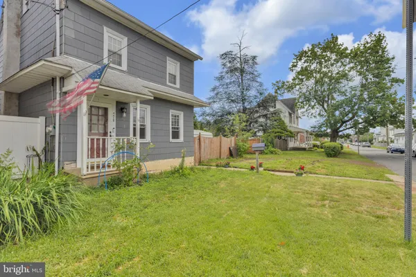 a view of a house with pool and a yard