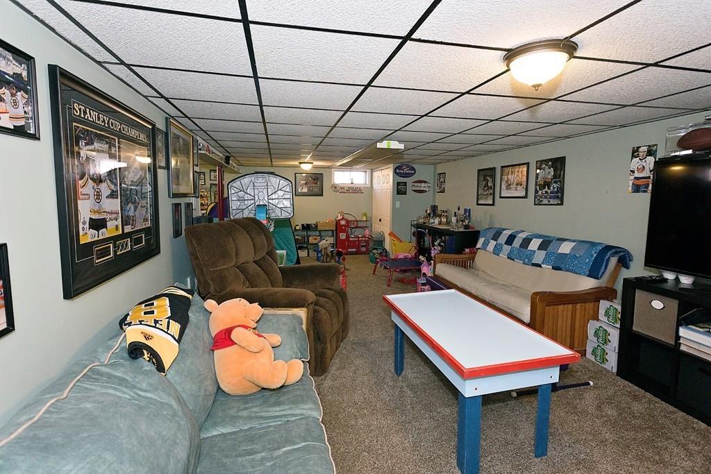 118 County Road Huntington, MA 01050 - Photo 25 of 32 a living room with furniture a chandelier and a flat screen tv