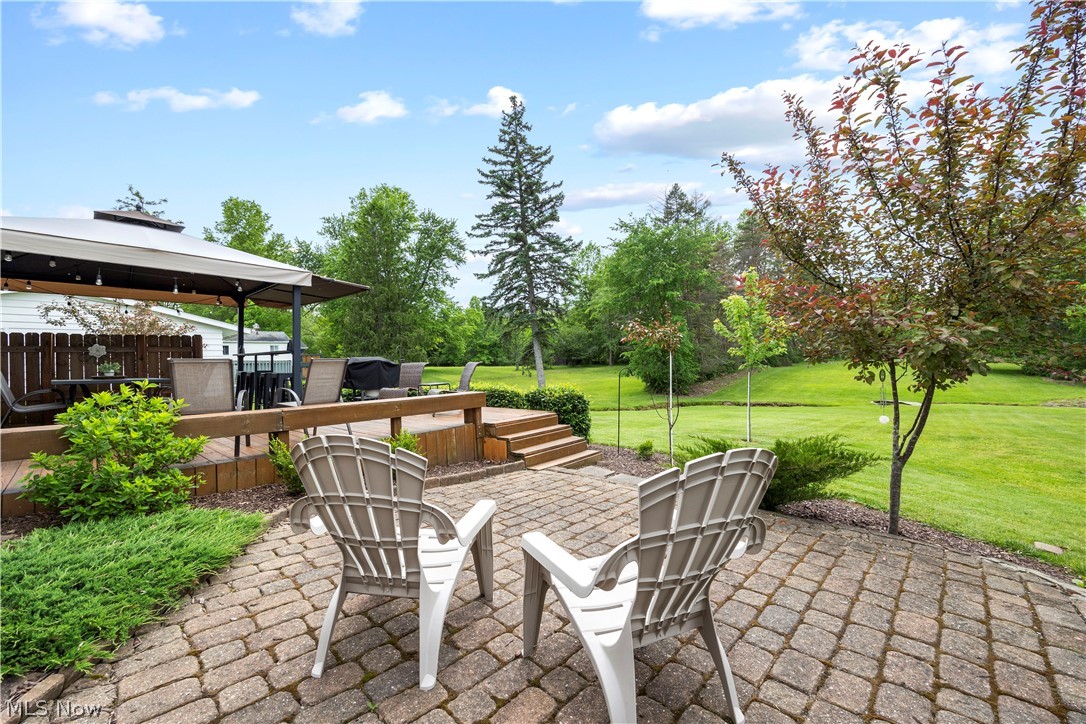 11492 Ridge Road North Royalton, OH 44133 - Photo 32 of 32 Expansive outdoor living area featuring a paver patio and a raised wood-finish deck with a built-in privacy fence