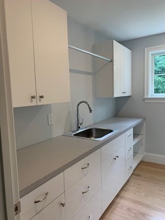 129 Centre Street Dover, MA 02030 - Photo 15 of 18 a kitchen with granite countertop white cabinets and a sink