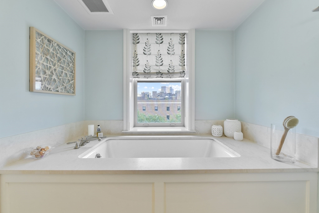 100 Beacon Street, Unit 6 Boston, MA 02116 - Photo 12 of 15 a bathroom with a bathtub sink and window