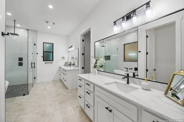 a spacious bathroom with double sink and a large mirror