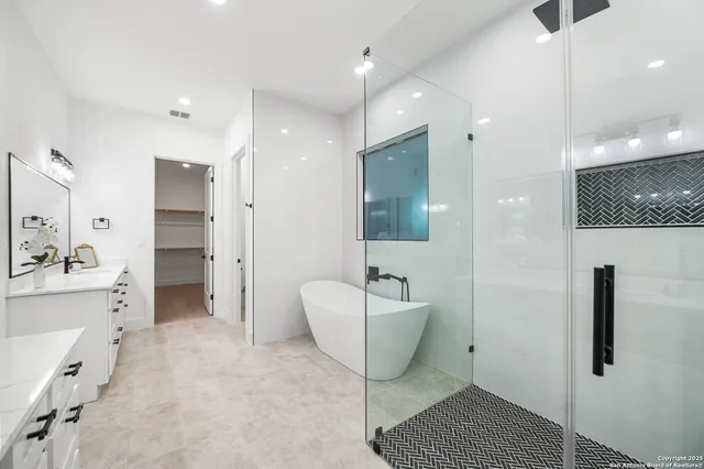 a spacious bathroom with a bathtub and a shower