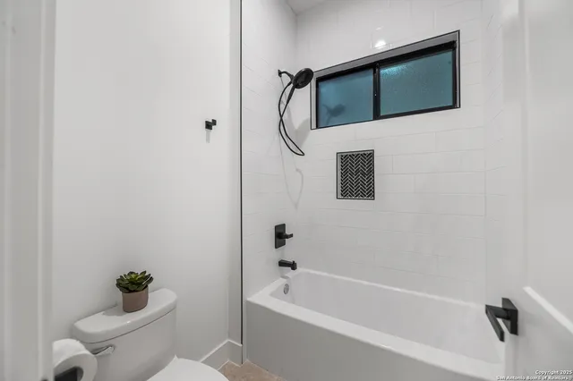 a bedroom with a bed potted plant and a window
