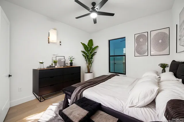 an empty room with a window and a ceiling fan