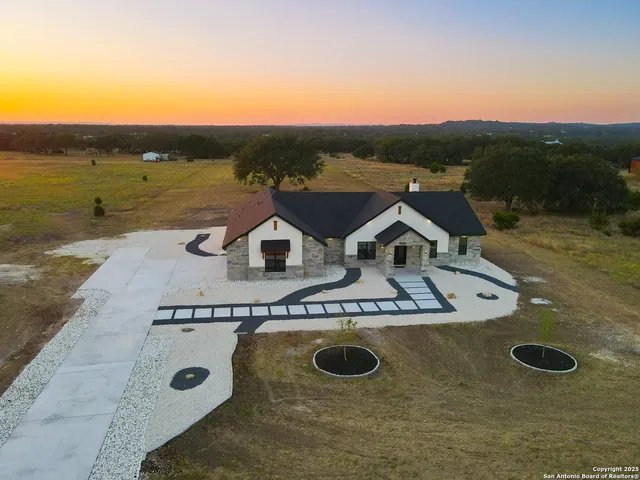 a view of a house with a yard and garage