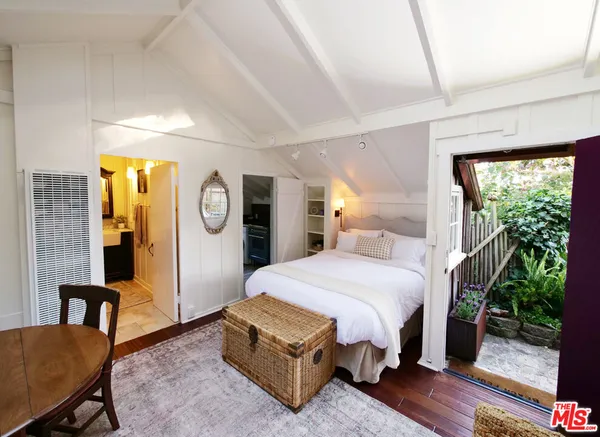 a bedroom with a bed couch and a window