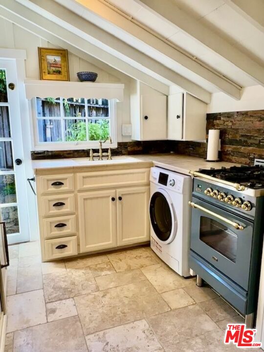 3 Monte Verde Street Carmel-by-the-Sea, CA 93923 - Photo 7 of 13 a kitchen with a stove a sink and a microwave