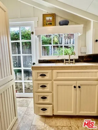 a view of a kitchen with a dishwasher and a large window