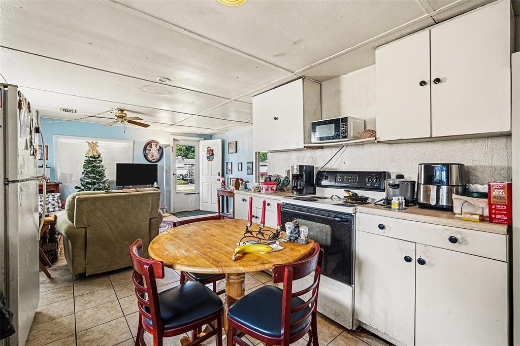 2518 Elm Street Seffner, FL 33584 - Photo 13 of 27 a kitchen with stainless steel appliances kitchen island granite countertop a table chairs and a refrigerator
