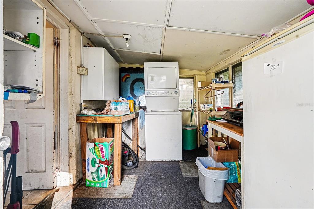 2518 Elm Street Seffner, FL 33584 - Photo 15 of 27 a utility room with stainless steel appliances a chimney and furniture
