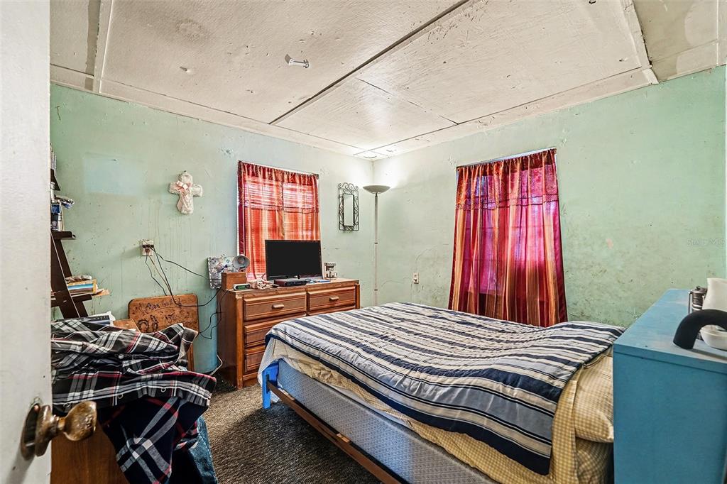 2518 Elm Street Seffner, FL 33584 - Photo 4 of 27 a bedroom with a bed and wooden floor