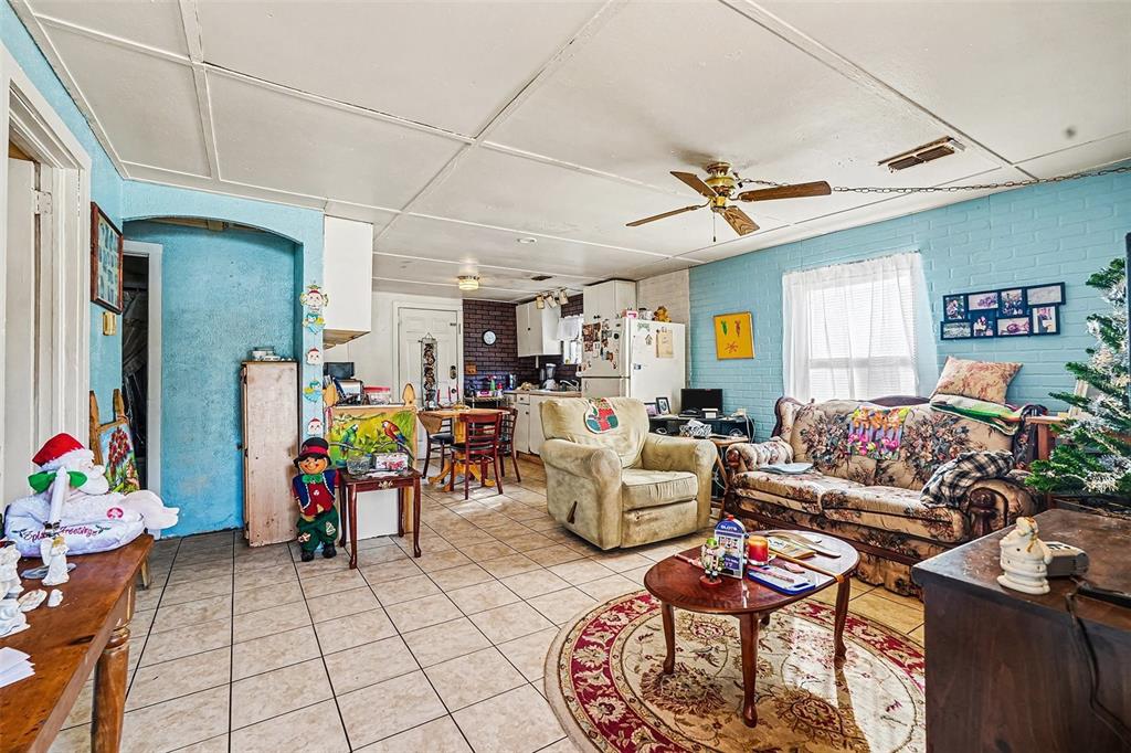 2518 Elm Street Seffner, FL 33584 - Photo 8 of 27 a living room with furniture a dining table and paintings on the wall