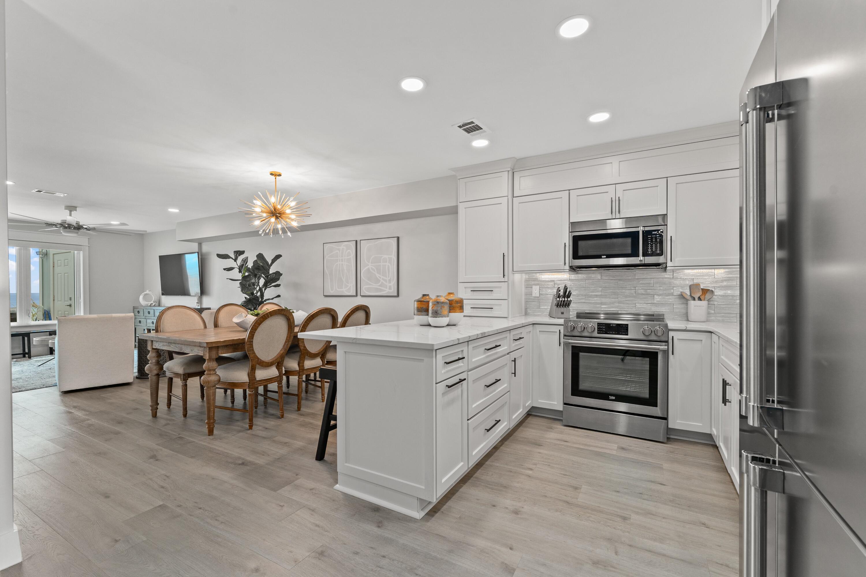 128 Blue Mountain Road, Unit 3 Santa Rosa Beach, FL 32459 - Photo 5 of 33 a kitchen with appliances a sink and counter top space