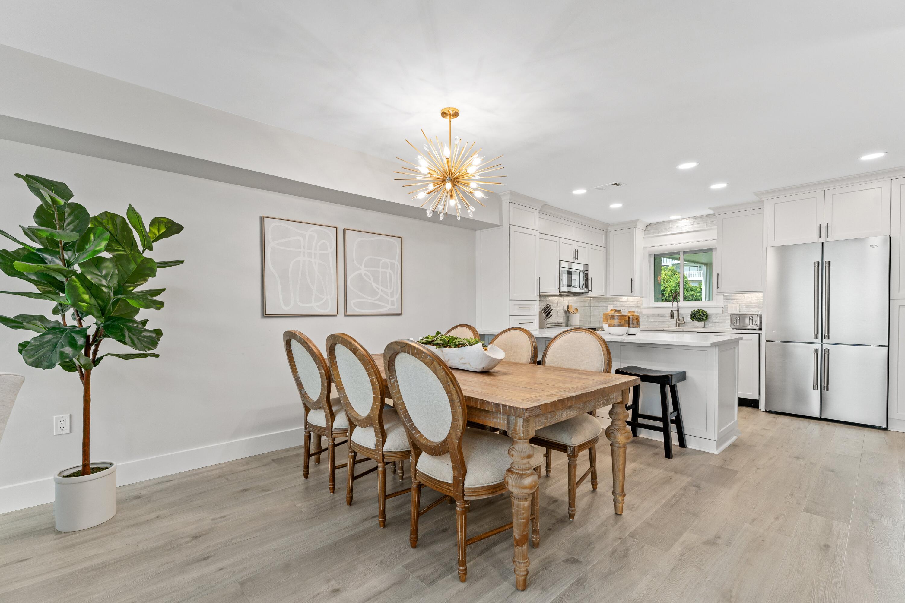 128 Blue Mountain Road, Unit 3 Santa Rosa Beach, FL 32459 - Photo 6 of 33 a dining room with furniture potted plants and wooden floor