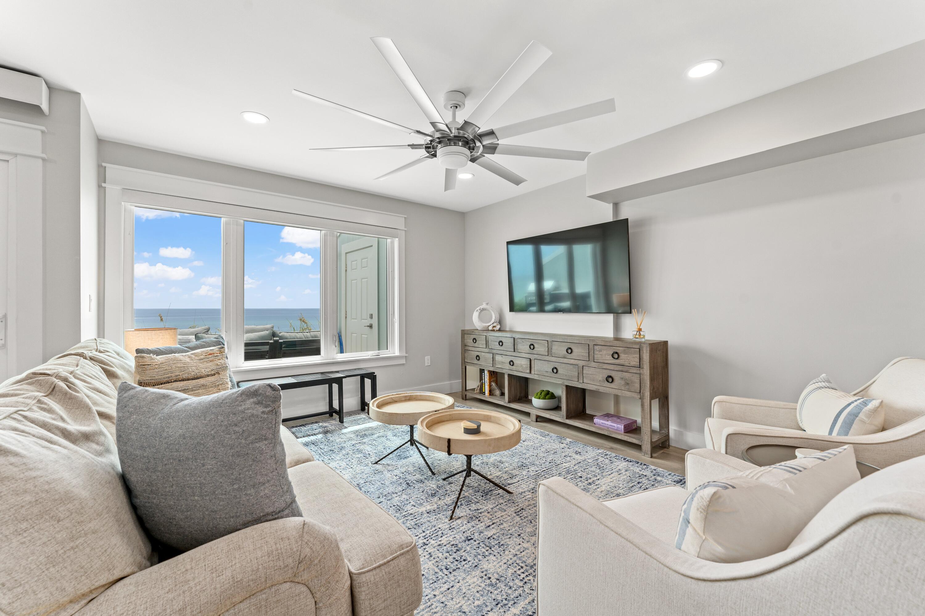 128 Blue Mountain Road, Unit 3 Santa Rosa Beach, FL 32459 - Photo 9 of 33 a living room with furniture a fireplace and a flat screen tv