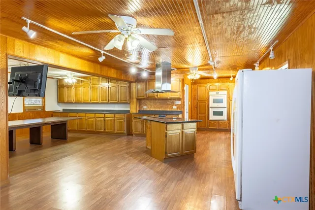 a view of a kitchen with a stove top oven