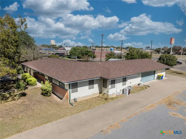 a aerial view of a house with a yard and garage