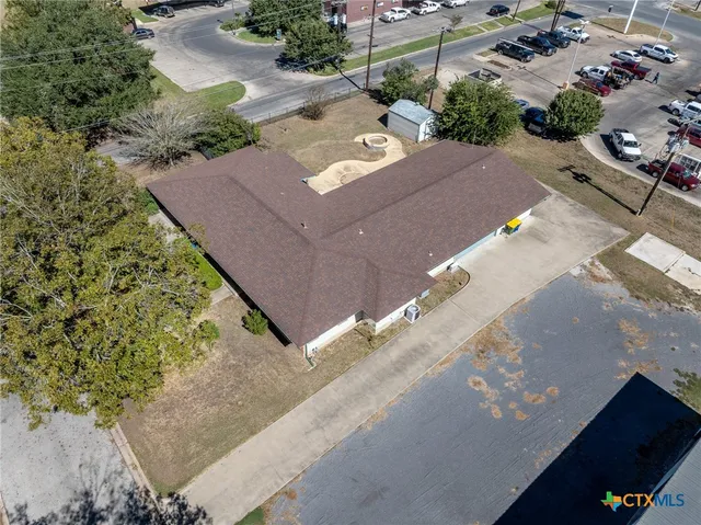 an aerial view of a house with a yard