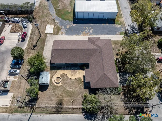 an aerial view of a house with a yard and garden