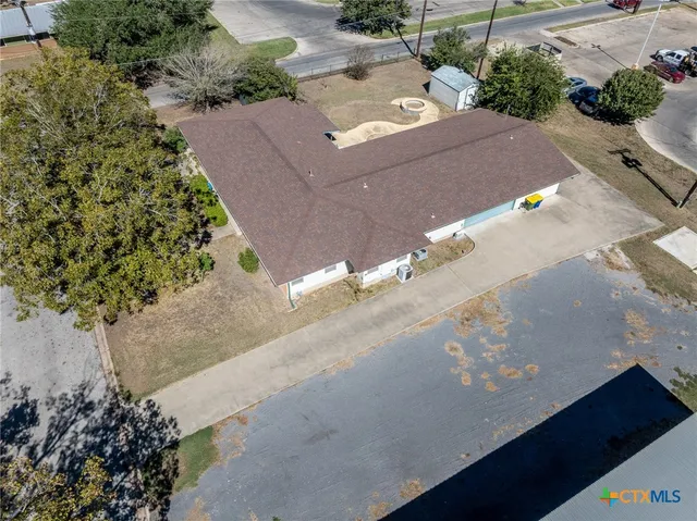 an aerial view of a house with a street