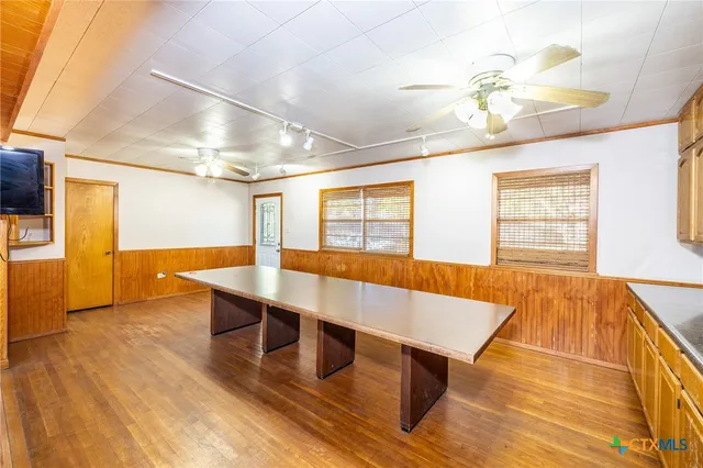 a view of a room with wooden floor