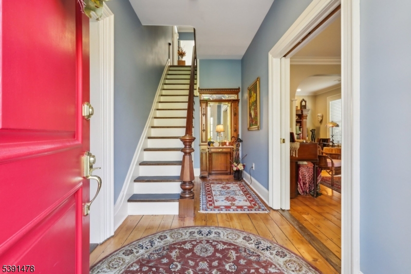 1035 Littleton Road Parsippany, NJ 07054 - Photo 3 of 47 a view of a hallway with wooden floor windows and a livingroom