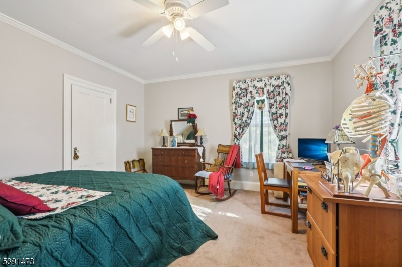 1035 Littleton Road Parsippany, NJ 07054 - Photo 36 of 47 a bedroom with a bed and a chandelier