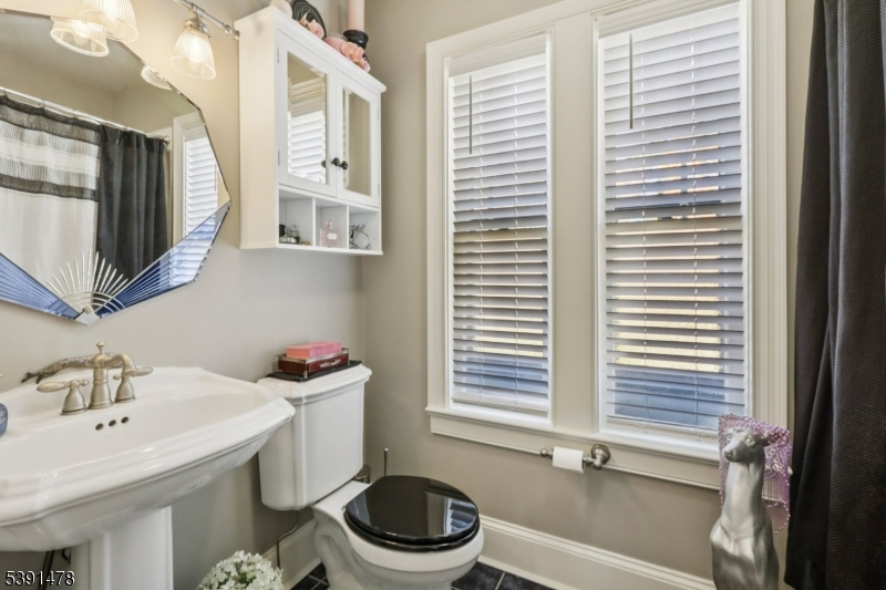 1035 Littleton Road Parsippany, NJ 07054 - Photo 37 of 47 a bathroom with a sink a toilet and a mirror