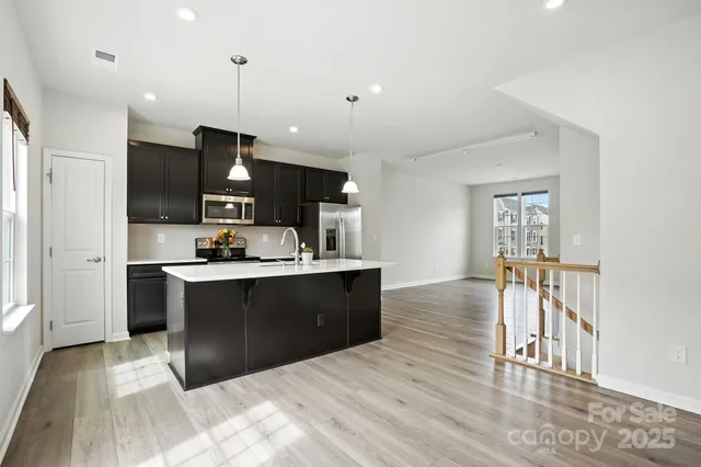 a kitchen with granite countertop stainless steel appliances and wooden cabinets