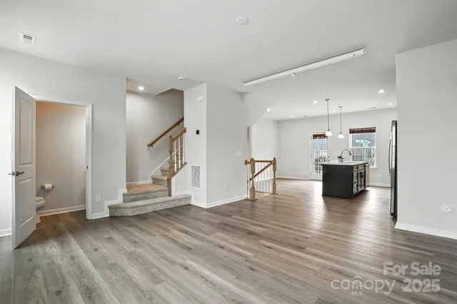 a view of kitchen with furniture and wooden floor
