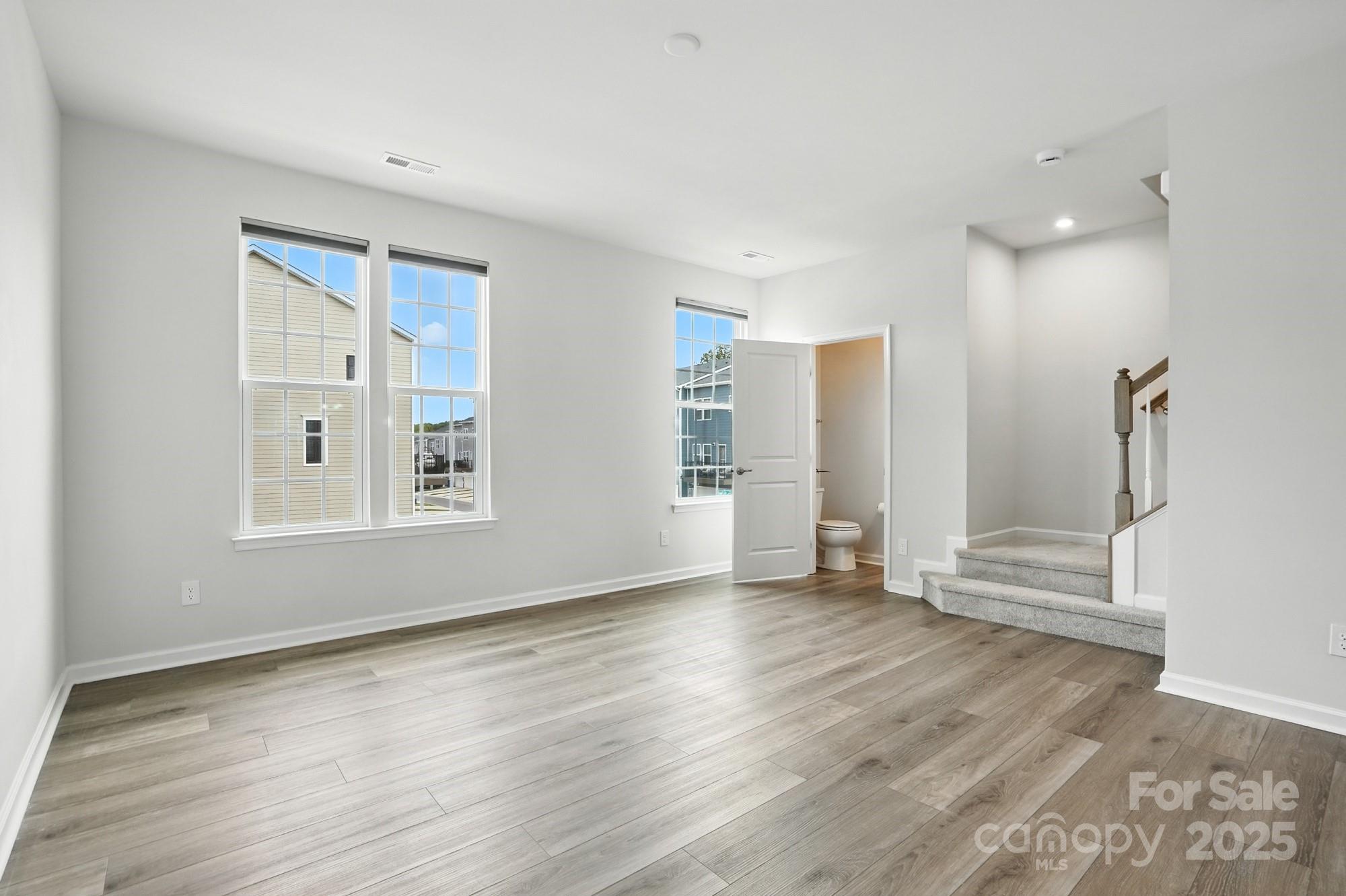 2108 Trout Lily Lane, Unit 198 Matthews, NC 28104 - Photo 25 of 45 a view of an empty room with wooden floor and a window