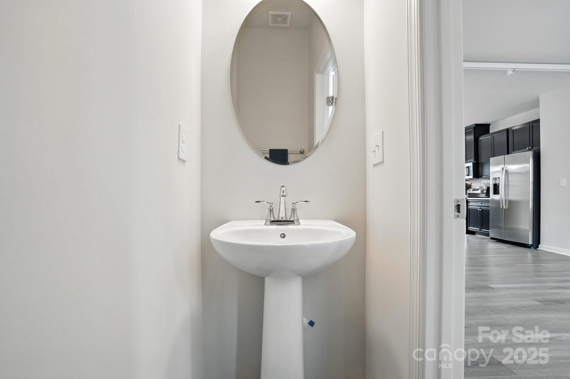 2108 Trout Lily Lane, Unit 198 Matthews, NC 28104 - Photo 27 of 45 a bathroom with a sink and a mirror