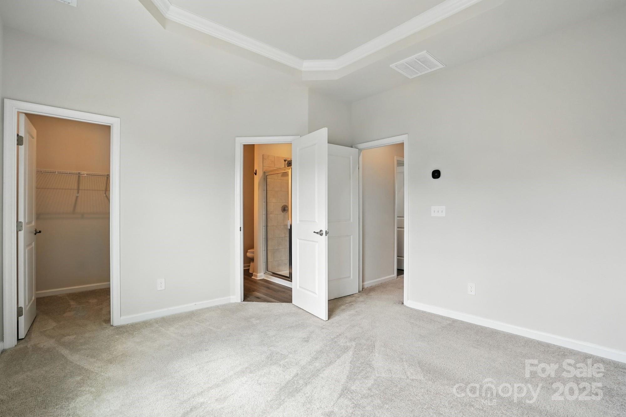 2108 Trout Lily Lane, Unit 198 Matthews, NC 28104 - Photo 29 of 45 an empty room with closet and mirror