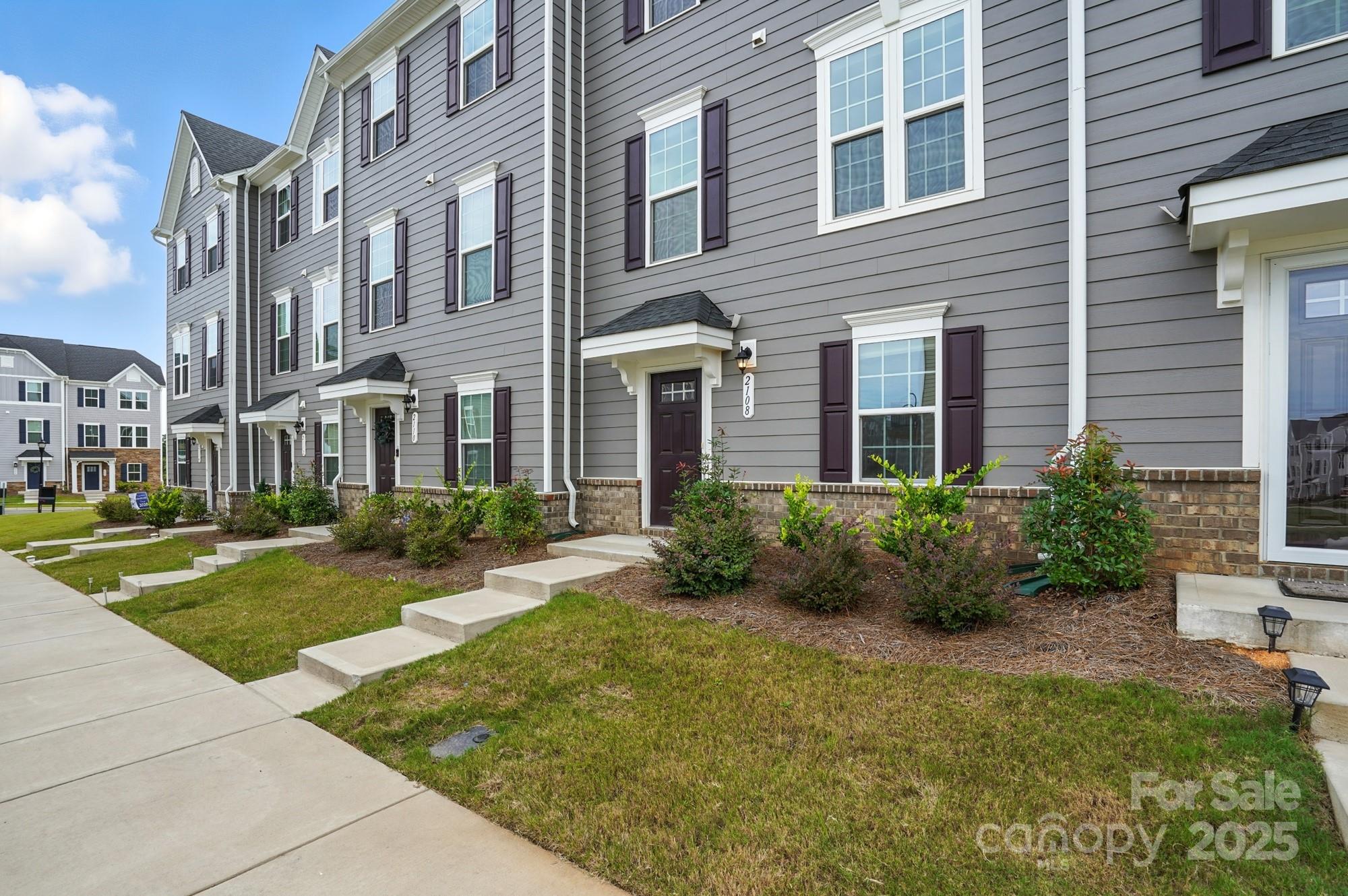 2108 Trout Lily Lane, Unit 198 Matthews, NC 28104 - Photo 3 of 45 a view of a building with garden