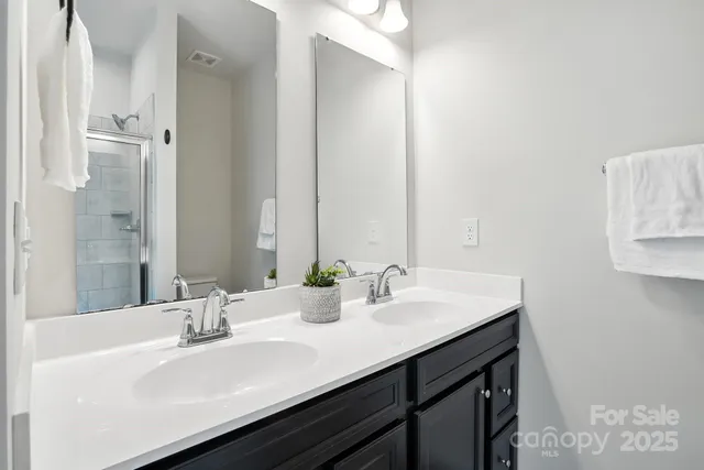 a bathroom with a glass shower door