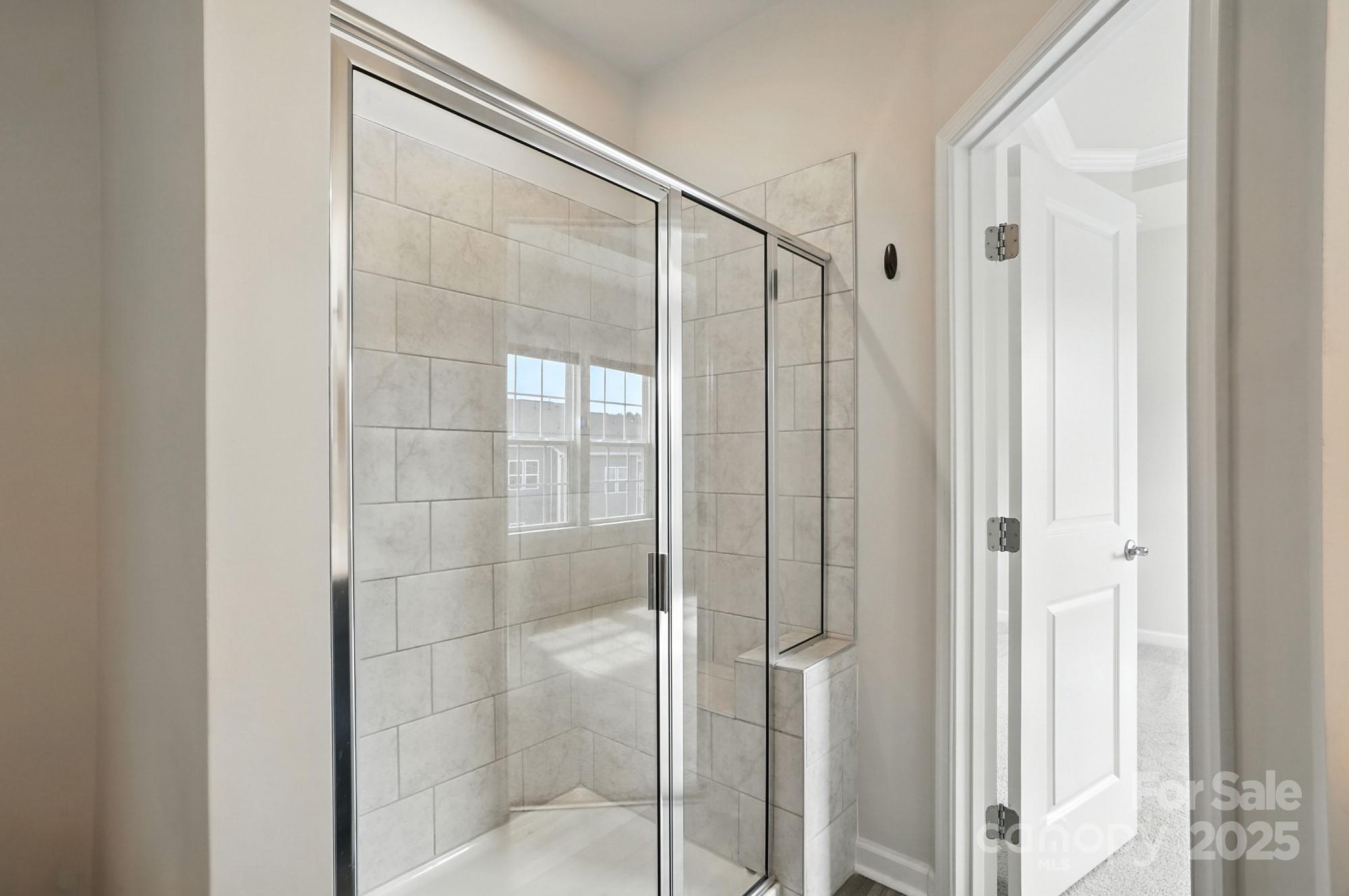 2108 Trout Lily Lane, Unit 198 Matthews, NC 28104 - Photo 33 of 45 a bathroom with a glass shower door