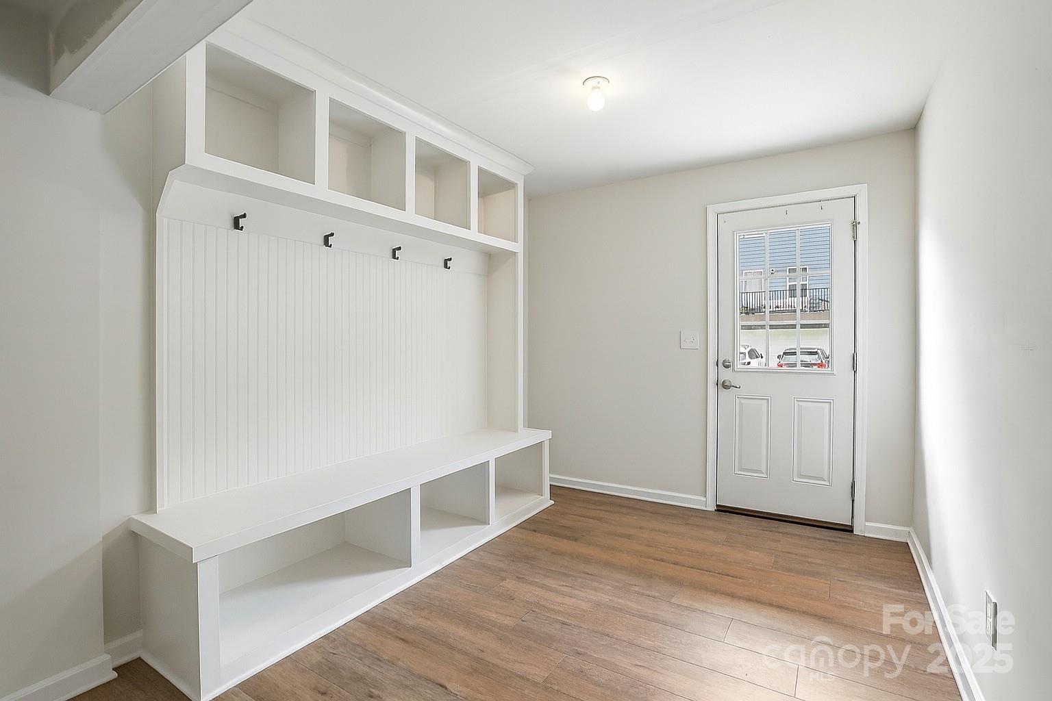 2108 Trout Lily Lane, Unit 198 Matthews, NC 28104 - Photo 8 of 45 a view of an empty room with wooden floor and closet