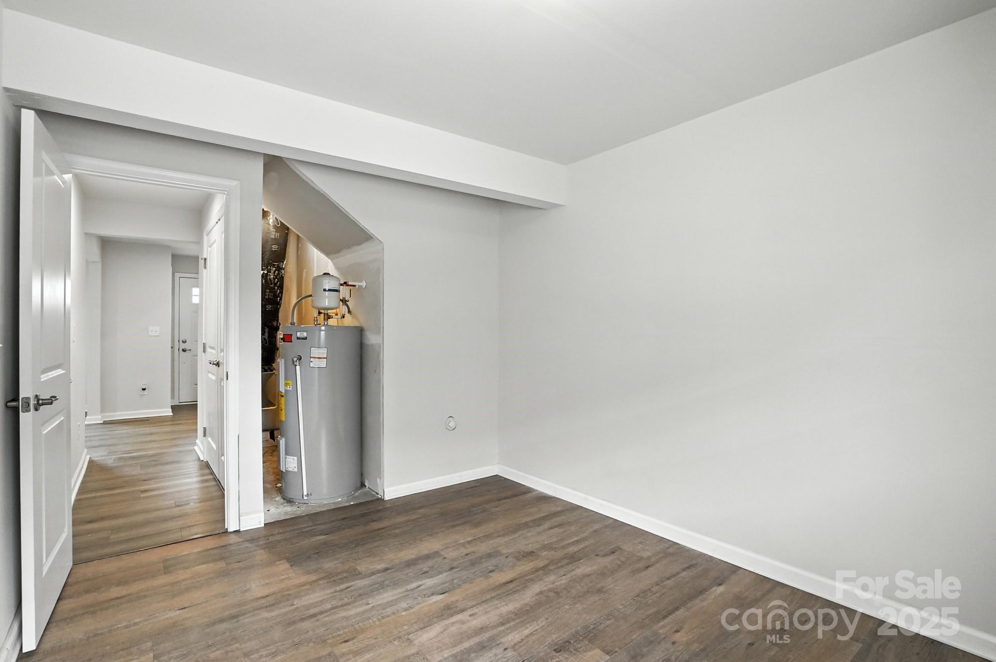 2108 Trout Lily Lane, Unit 198 Matthews, NC 28104 - Photo 9 of 45 a view of a hallway with wooden floor