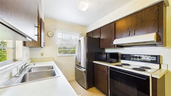 a kitchen that has a sink and a stove