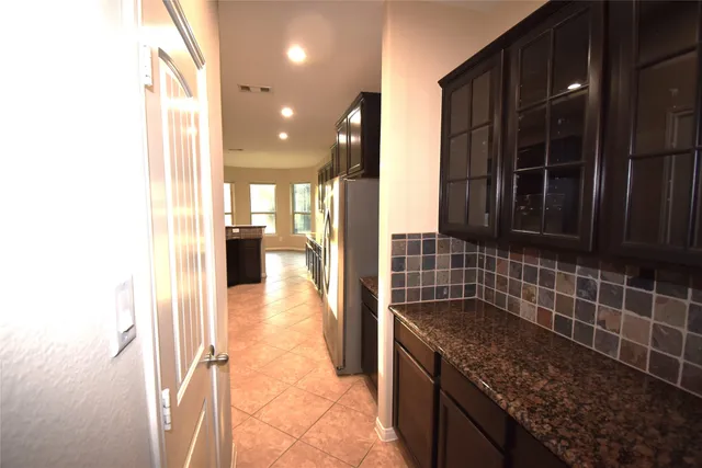 a kitchen with granite countertop a sink and a stove