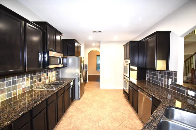 a large kitchen with granite countertop lots of counter top space